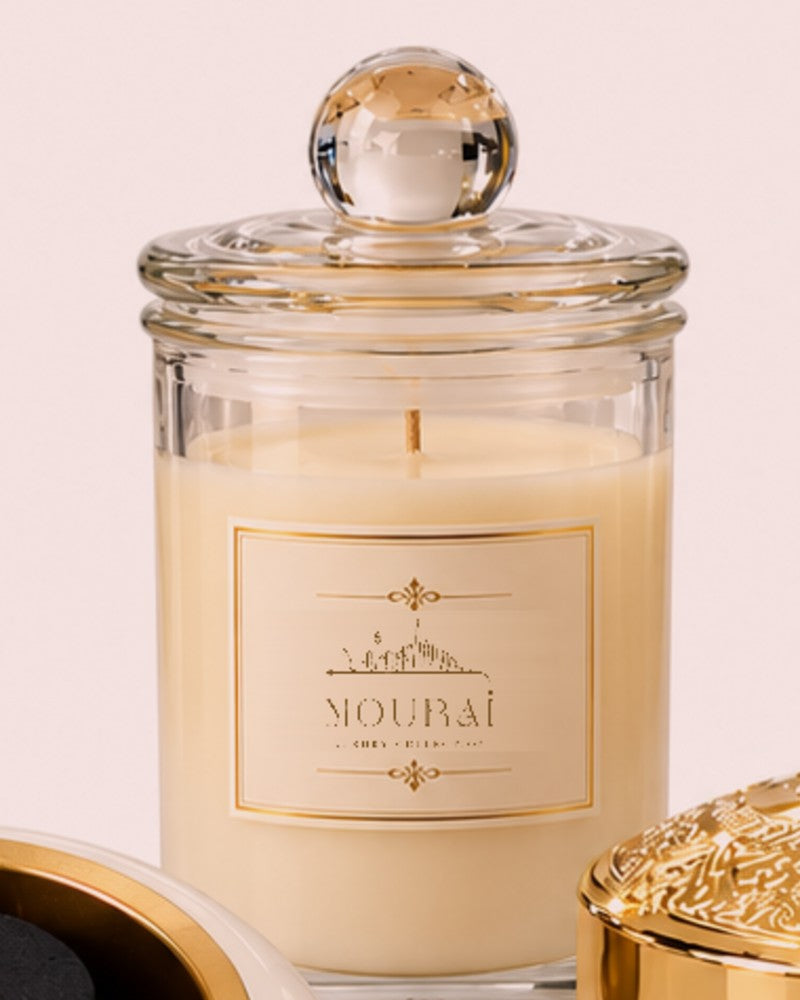 Nourai scented candle in a glass jar with gold label